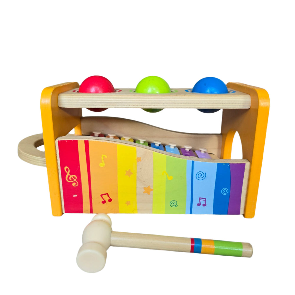 "Hape's Pound and Tap Bench with Slide Out Xylophone is a multifunctional musical delight and sound experience for toddlers.

Toddlers ages 12 months to 3 years can explore different notes and sounds by letting the balls fall on the keys or slide out the xylophone to create their own unique sound with a wooden mallet.

This musical instrument allows for different sounds and melodies making it the ideal introduction to the exciting world of music for your child."