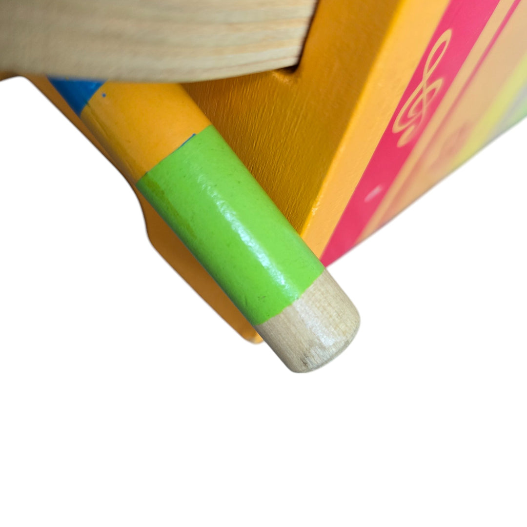 "Hape's Pound and Tap Bench with Slide Out Xylophone is a multifunctional musical delight and sound experience for toddlers.

Toddlers ages 12 months to 3 years can explore different notes and sounds by letting the balls fall on the keys or slide out the xylophone to create their own unique sound with a wooden mallet.

This musical instrument allows for different sounds and melodies making it the ideal introduction to the exciting world of music for your child."