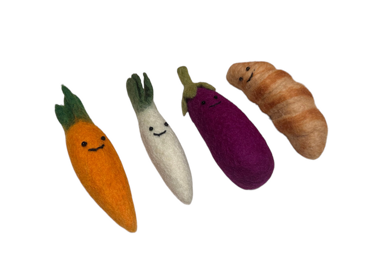 Bundle of veg and croissant with smiley faces