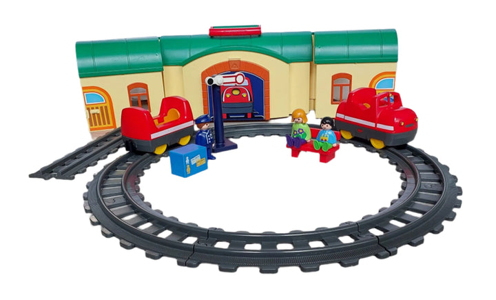 Playmobil, 6783 Take Along Train Set, All aboard! Cruise down the tracks on the My Take Along Train, With a bright and colorful design and large, rounded pieces, this Playmobil 1.2.3 set is ideal for toddlers, Train station doubles as a carrying case, making it the perfect set for toddlers on the go, Simply unlatch the side to reveal storage space for the three figures, two train cars, tracks, bench, suitcase, and traffic sign, Encourages children to explore and learn while having fun.