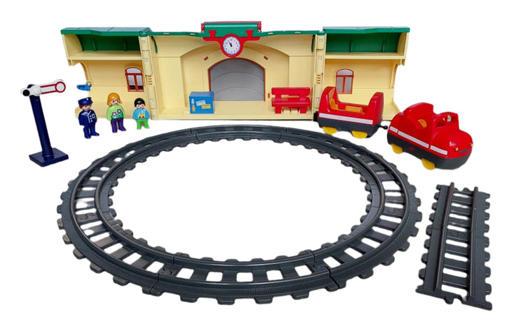 Playmobil, 6783 Take Along Train Set, All aboard! Cruise down the tracks on the My Take Along Train, With a bright and colorful design and large, rounded pieces, this Playmobil 1.2.3 set is ideal for toddlers, Train station doubles as a carrying case, making it the perfect set for toddlers on the go, Simply unlatch the side to reveal storage space for the three figures, two train cars, tracks, bench, suitcase, and traffic sign, Encourages children to explore and learn while having fun.